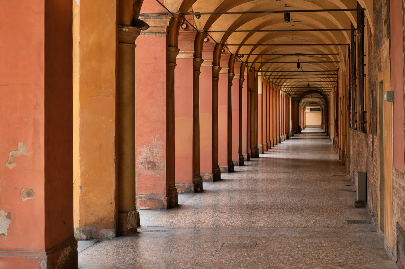 Bologna's historic porticoed streets near the train station for a Parma day trip from Bologna